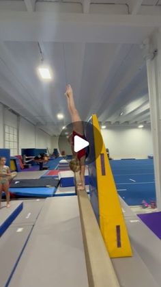 a person on a balance beam in a gym