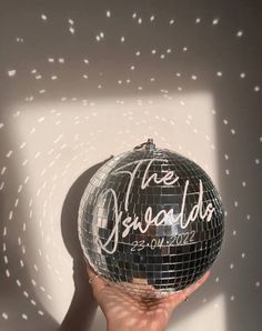 a person holding a disco ball in their hand with the words the specials written on it