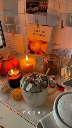 a table topped with candles and bowls filled with food