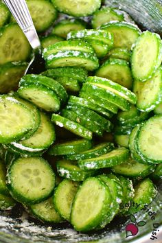 a glass bowl filled with sliced cucumbers