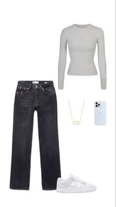 a woman in grey sweater and jeans is wearing white sneakers, a necklace, and a phone