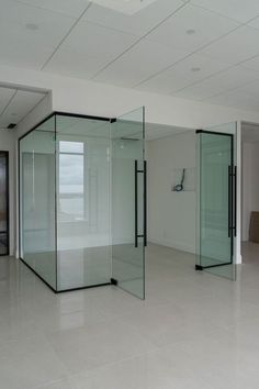 an empty room with glass partitions and no doors on the walls in front of it