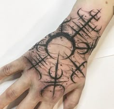 a person's hand with a tattoo on it