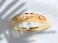 "**Seal Your Promise with a Sparkle: The Pinky Promise Ring  Step into a world where a tiny band of gold is a powerful symbol of fidelity and friendship. Introducing the Pinky Promise Ring, a delicate piece that wraps your finger in a warm embrace and holds a whispered pledge close to your heart. Perfect as a dainty pinky ring or as a subtle addition to your ring stack, this beauty is a reminder of the promises that matter most. 🌟 Made with love, this ring is plated in luxurious 14K gold over a Meaningful Gold Jewelry For Promise, Gold Engraved Promise Ring With Meaningful Style, Meaningful Gold Promise Jewelry, Gold Meaningful Engraved Promise Ring, Meaningful Gold Engraved Promise Ring, Vintage Gold Engraved Promise Ring, Gold Jewelry With Engraved Text For Promise, Weding Rings, Pinky Promise Ring