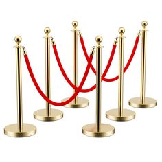 a set of four red rope barriers with gold posts