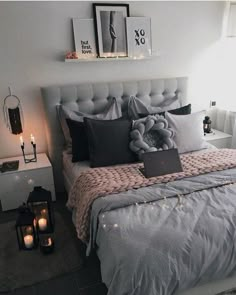 a bed room with a neatly made bed and candles