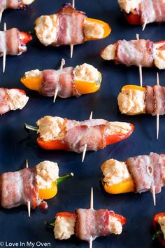 bacon wrapped peppers on skewers are ready to be served for the guests at a party