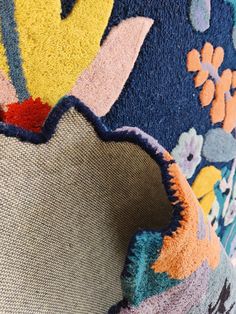 closeup of the back of a colorful floral patterned chair with an upholstered seat