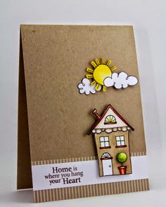 a handmade card with a house and sun on the top that says home is where you hang your heart