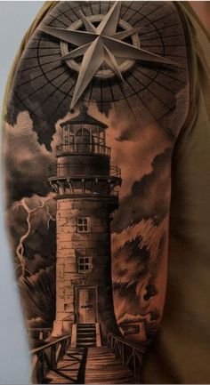 a man with a lighthouse tattoo on his arm