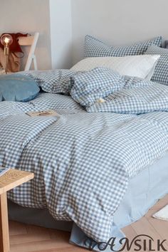 a blue and white checkered comforter on a bed