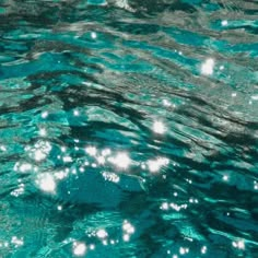 the water is very clear and blue with little bubbles on it's surface,