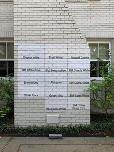 a white brick building with writing on it