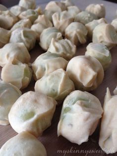 some dumplings are sitting on a cutting board