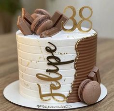 a birthday cake decorated with chocolate and macaroons