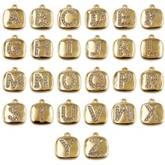 gold alphabet charms with diamonds on them