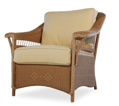 a wicker chair with beige cushions on an isolated white background