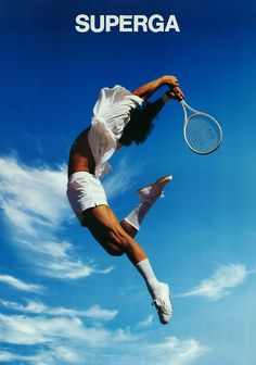 a woman jumping up into the air with a tennis racket in her hand, on a blue sky background