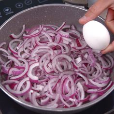 onions being boiled in a pan on the stove