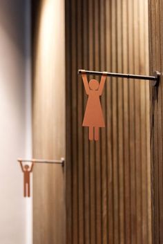 a paper cut out of a woman hangs on a clothes line in front of a door