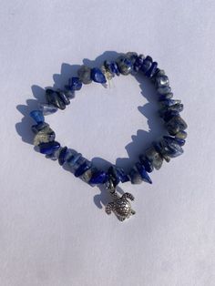 This is a blue rock bead bracket with a silver turtle charm Adjustable Blue Crystal Bracelet With Stones, Casual Blue Jewelry With Natural Stones, Tiny Bead Bracelet, Beaded Ankle Bracelets, Blue Rock, Beaded Memory Wire, Beaded Ankle, Blue Clay, Doll Diy Crafts