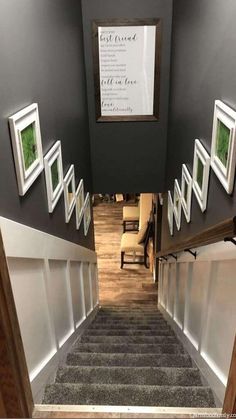 an overhead view of stairs leading up to a room with pictures on the wall above them