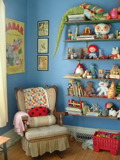 a child's room with blue walls and lots of toys on the shelfs