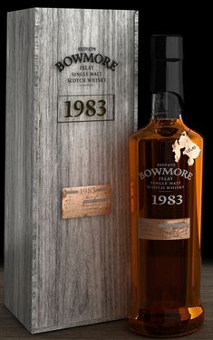 a bottle of whisky sitting next to a wooden box