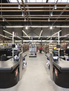 the inside of a grocery store with people shopping