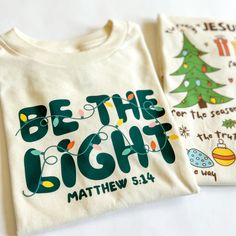 Spread the light of Christmas with this festive kid-sized unisex shirt. Featuring a stylish Christian design, it's the perfect way for your little one to celebrate the season with family and friends. Get ready to spark joy and be the light! Cricut Throw Pillows, School Christmas Shirt, The Joy Of Christmas Is Family, Christian School Shirt Designs, Popular Christmas Shirts, Christmas Shirts Boys, Sublimation Shirts Christmas, Cute Christmas T Shirts, Christmas Christian Tshirts