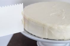 a close up of a cake on a plate with a piece of paper stuck to it