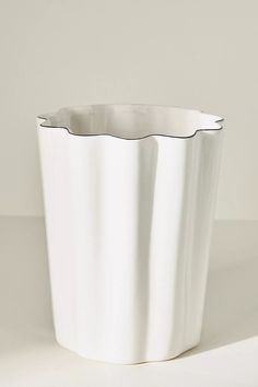 a white vase sitting on top of a table