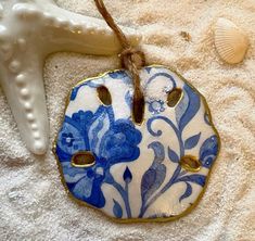 a blue and white ceramic ornament on a towel next to a starfish