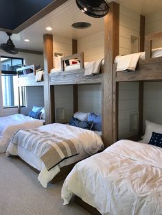 a room with bunk beds and pillows on the floor