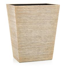 a square planter made out of straw with a black liner on the top and bottom