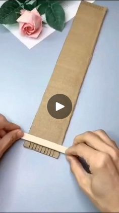 someone is cutting out a piece of cardboard with scissors