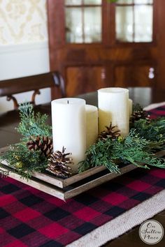 a table with candles and pine cones on it