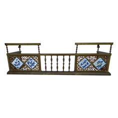 an iron balcony railing with blue and white tiles on the sides, set against a white background