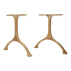 a pair of gold metal stools sitting next to each other on a white background