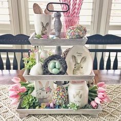 a three tiered tray with easter decorations on it