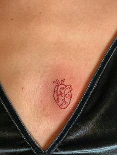 a small heart tattoo on the chest