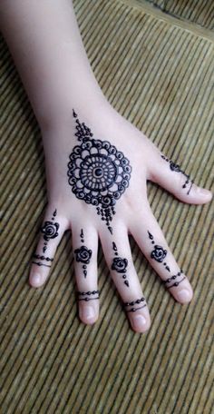 a person's hand with henna tattoos on it