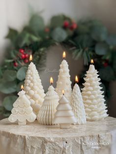 small white christmas trees sitting on top of a table