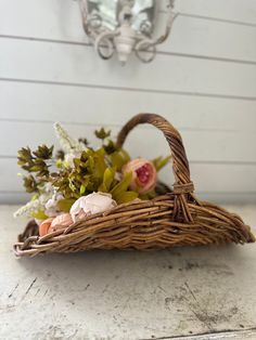 a basket filled with flowers sitting on top of a table