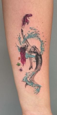 a woman's leg with a mermaid tattoo on it