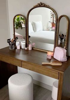 a vanity table with a mirror and stool