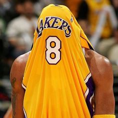 a basketball player wearing a yellow jersey with the number 8 on it's back