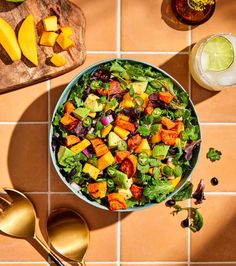 a salad with mangos, lettuce and other vegetables