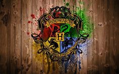 the hogwarts crest painted on a wooden wall