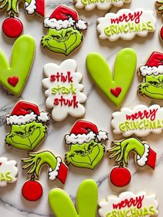 the grinch cookies are decorated with green and red icing